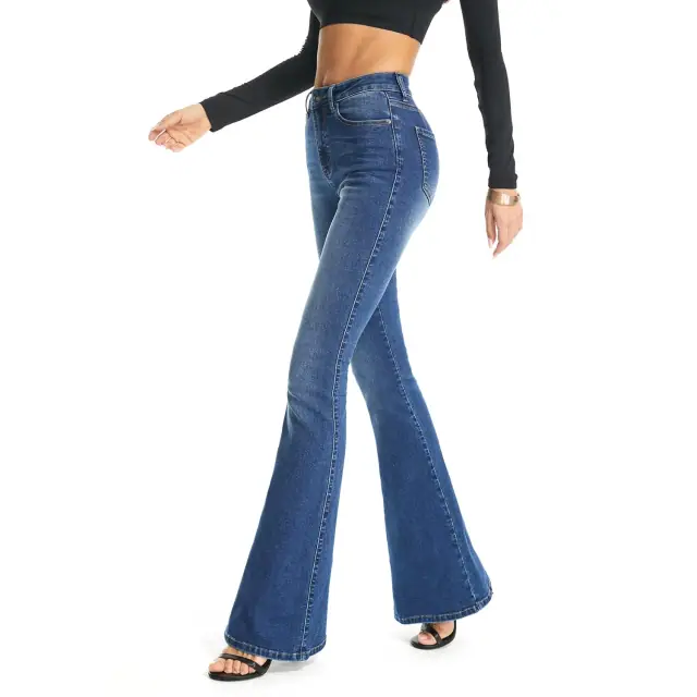 Side view of blue bootcut flare jeans styled with a black long-sleeved top and heeled sandals.